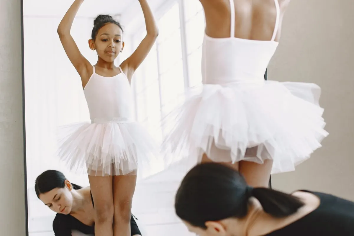 Young dancer practising ballet in soft canvas shoes.